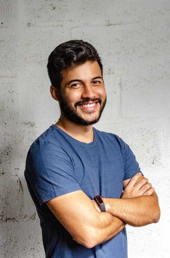 pexels-photo-2379004-2379004 Portrait Photo of Smiling Man with His Arms Crossed Standing In Front of a Wall